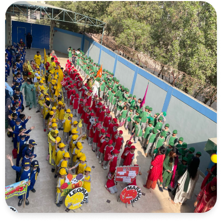 Students in school assembly parade with color-coded uniforms and band