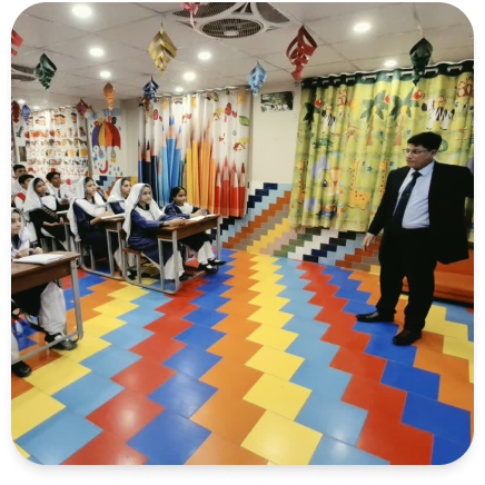Classroom interactive session with teacher standing on colorful chevron floor